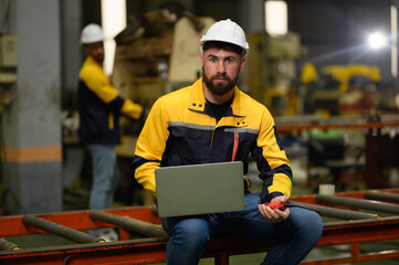 Technician maintains and inspects metal sheets in a metal cheese plant with computers and radio...