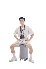 Ready for Adventure: A youthful traveler, camera in tow, exudes confidence and anticipation while perched upon his suitcase, fully prepared for his upcoming journey. 