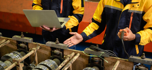 Technician maintains and inspects metal sheets in a metal cheese plant with computers and radio...