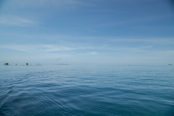 Beautiful tropical island in the Pacific Ocean with mangrove forests and coastal almond trees. A tropical island with calm waves and clear skies