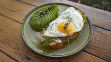 Sandwich with avocado, boiled egg for healthy breakfast on wooden table background. top view. Healthy diet food
