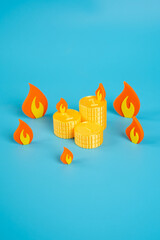 Stacks of coins surrounded by fire. Savings in the fire of inflation and devaluation. Financial...