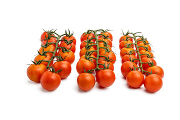 Three neat rows of cherry tomatoes on a vine, evenly spaced. The tomatoes are glossy and vibrant,...