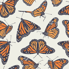 Vintage seamless pattern with hand drawn orange monarch butterflies on beige background. Repeat wallpaper of beautiful tropical insect