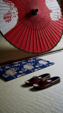 Traditional japanese room showing wagasa parasol, zori sandals and zabuton cushion