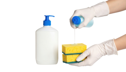 A pair of gloved hands squeezing liquid soap from a blue bottle onto a yellow kitchen sponge with a scrubber side.