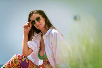 Attractive brunette haired woman relaxing outdoor