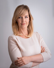 Blond haired woman standing against isolated background