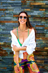 Cheerful woman relaxing by the wall outdoor