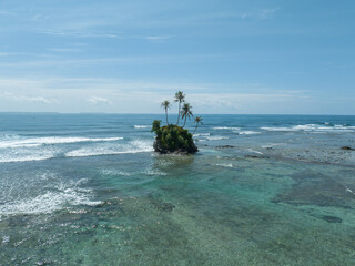 Aerial view of a beautiful small tropical island. Aerial view of a small island in the middle of a turquoise ocean