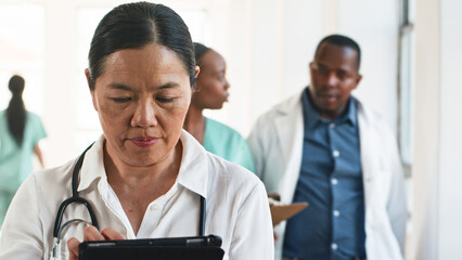 Medical Professionals Collaborating in a Busy Hospital Corridor