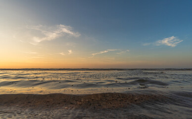Sunset, Sky clouds over sea in the evening with orange, yellow gold sunlight sun dawn in Golden hour and dramatic fluffy, Horizon morning sunny sunrise sea summer sky landscape, Dusk sky background