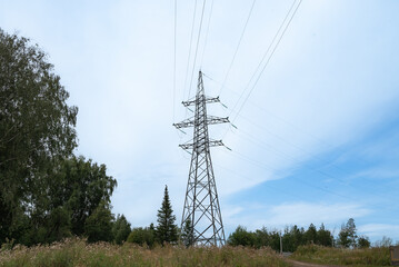 Power substation with high-voltage towers and cables in a rural area..