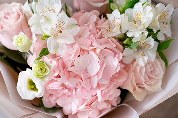 Beautiful bouquet of pink and white flowers arranged elegantly for a special occasion in a cozy setting