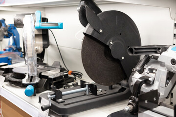 Various cutting tools and machinery displayed on a workshop shelf, showcasing their features and...