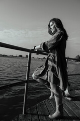 A girl with a guitar in cowboy style. Cowboy hat and boots. Sunny atmospheric photos.