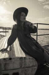 A girl with a guitar in cowboy style. Cowboy hat and boots. Sunny atmospheric photos.