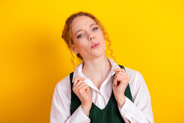 Young student with expressive gesture against vibrant yellow background showcasing modern casual...