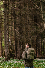 Man Hiker Walking through Spring Forest