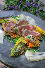 Tuna steak on pearl barley, roasted pak choi vegetables and a fine cream