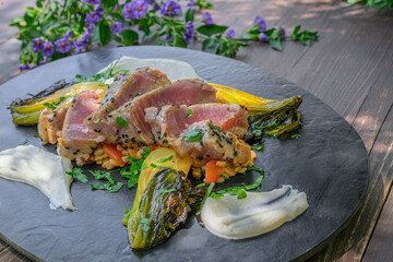 Tuna steak on pearl barley, roasted pak choi vegetables and a fine cream