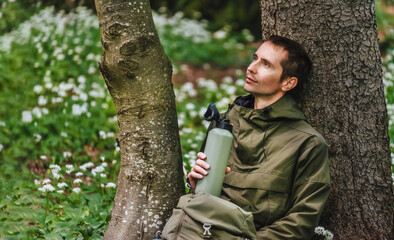 Man Walking through Blooming Forest Glade