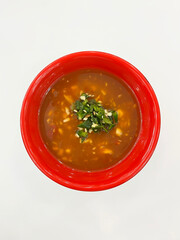 Thai spicy dipping sauce in red bowl, top view