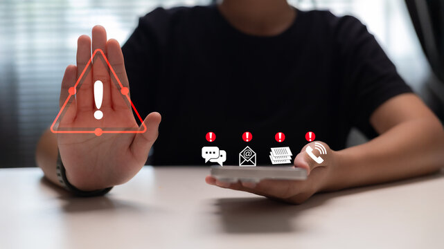 Person raising hand to stop multiple digital warnings from messages, emails, documents, and calls, symbolizing cybersecurity alert and protection against online threats.