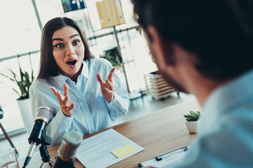 Professional interview setting with coworkers engaged in conversation in a well-lit office space