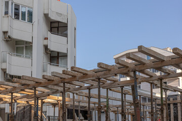 Reinforcement of reinforced concrete columns. The formwork of the columns. Construction technology. A crow stands on scaffolding at a construction site.