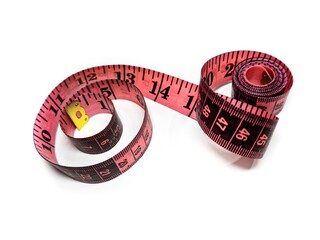 Pink measuring tape on a white background. Centimeter and inch tools for measuring the length or volume of the human body in the clothing industry.