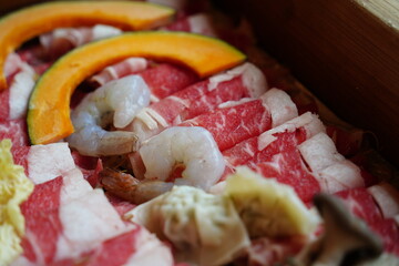 Healthy Korean Steamed Meal with Pork, Shrimp, and Fresh Vegetables in Wooden Steamer