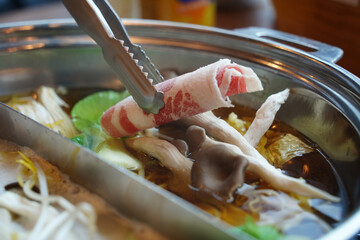 Hot Pot with Thinly Sliced Meat and Fresh Vegetables – Close-Up of Cooking Moment