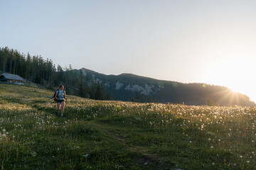 Obraz premium woman walking in the field in the mountains