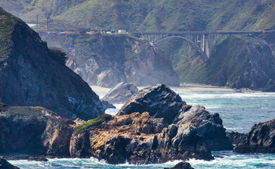 Bixby Creek Bridge along Highway 1 in Big Sur, California. A dramatic view of rugged cliffs,...