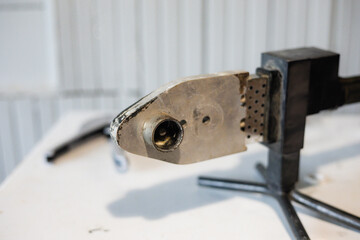 Soldering iron for soldering polypropylene pipes. The soldering iron has signs of wear and use,...