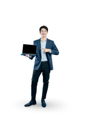 A smiling young man in a suit points at a laptop with a blank screen, ideal for showcasing a website, app, or specific feature.
