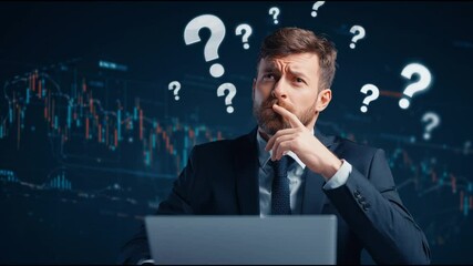 confused man in business suit works with laptop under question marks, digital financial graphs in background represent uncertainty and decision-making in the office setting - Powered by Adobe