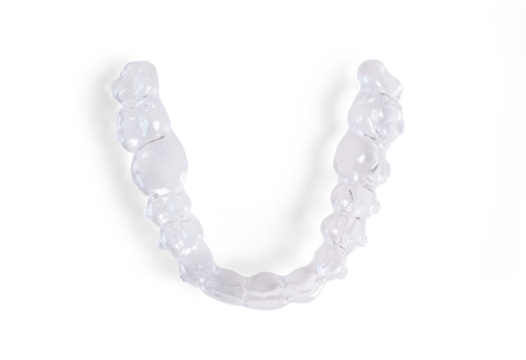 Invisible braces lying on a transparent background representing modern dental healthcare