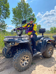 Quad bike ride on dirt roads in nature, vertical shooting