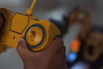 Remote control a childs hands grip a toy.
