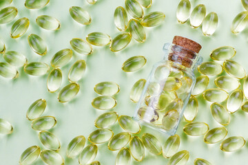 Transparent bottle with yellow capsules. Healthy concept. Pharmacy background.