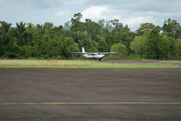 Slow motion video of a small turboprop plane lands at a remote airport