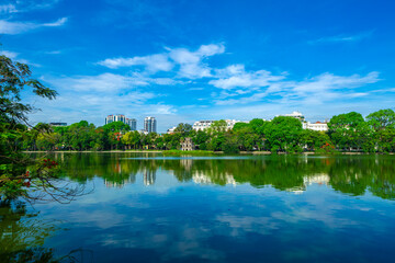 View of Turtle Tower at Hoan Kiem Lake in spring with beautiful reflection, an important historical building in Hanoi, Vietnam