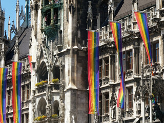 The frontal facade of the gothic New Town Hall of Munich in Marienplatz decorated by the LGBT flags for the June parade