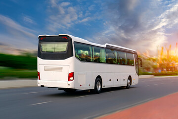 White tourist bus driving fast on highway and viaduct through city on street final destination rear...