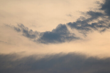 Cloudscape Serenity: Captivating clouds dance across a muted sky, evoking a sense of calm. Witness the subtle interplay of light, creating a visual tapestry that invites contemplation and peace.