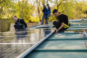 Workers installing solar panels on a residential roof