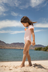 Little girl walking on sand at the beach in Arizona near Colorado river
