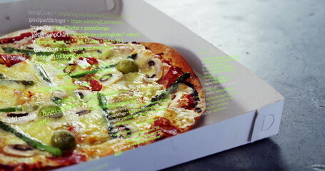 Displaying pizza in white box on grey tabletop with vegetable toppings and code overlay, copy space